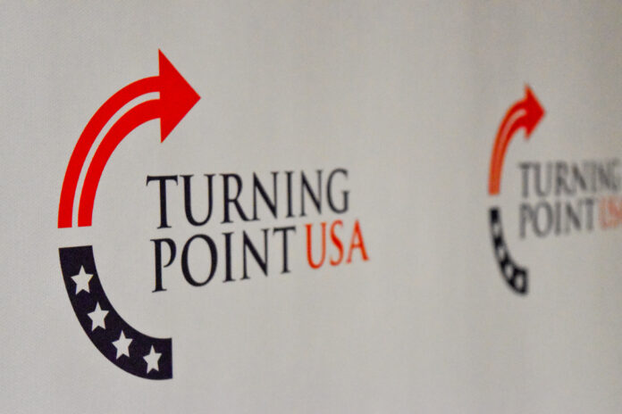 Logo of Turning Point USA displayed on a backdrop