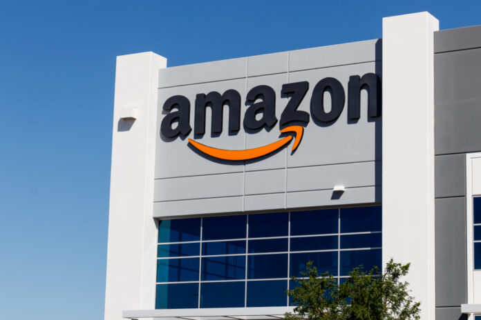 Exterior view of an Amazon building with a prominent logo