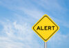Mystery Package Empties Lawmaker’s Office Yellow alert sign against a blue sky
