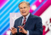 Greg Abbott in suit speaking at an event.