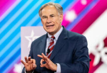Texas Shocker: Abbott Hit Greg Abbott in suit speaking at an event.