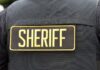 Morning Horror Stuns State Close-up of a sheriff's uniform with a badge