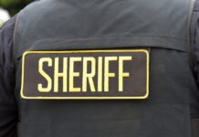 Close-up of a sheriff's uniform with a badge