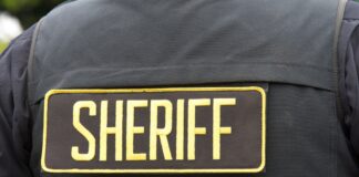 Close-up of a sheriff's uniform with a badge