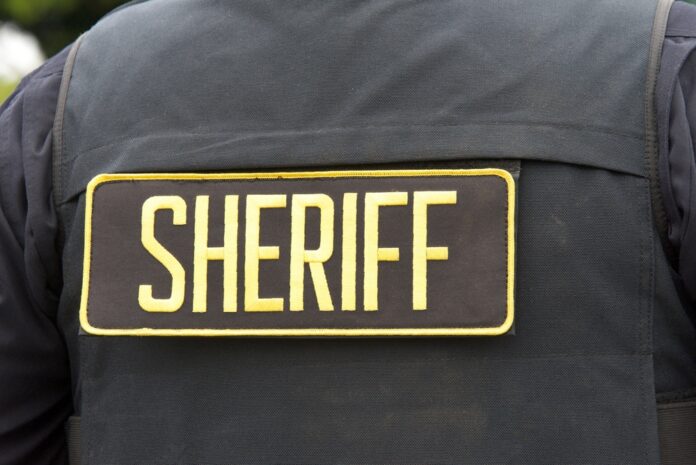 Close-up of a sheriff's uniform with a badge