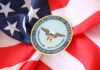 Pentagon Slams Troops – Enemies Watching Department of Defense emblem on American flag