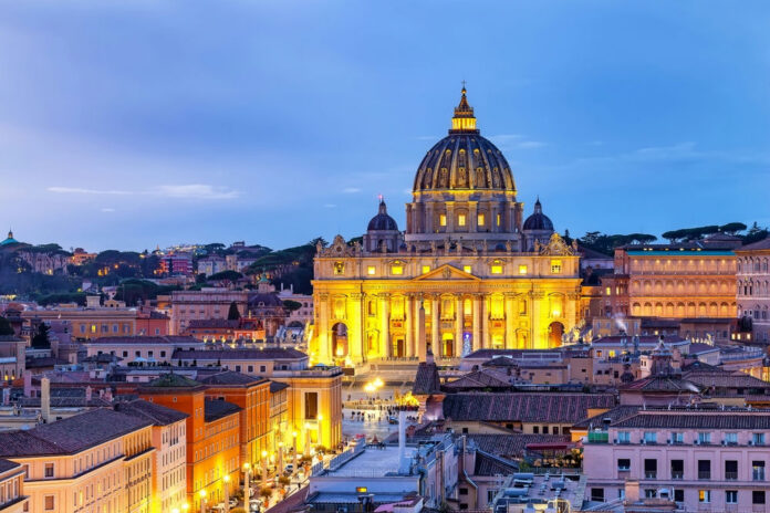 Illuminated St Peters Basilica at dusk Rome skyline