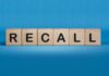 Wooden blocks spelling recall on a blue background