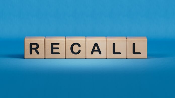 Wooden blocks spelling recall on a blue background