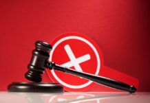 Judge Slams White House Ban Judge's gavel with a red cross symbol in the background