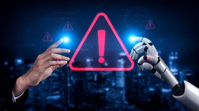 Human and robot hands touch a glowing warning icon