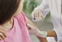 Unexpected Win: Young Adult Shingles Dives Healthcare worker gives a vaccine injection in a child's upper arm