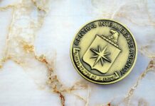 CIA emblem coin on marble surface