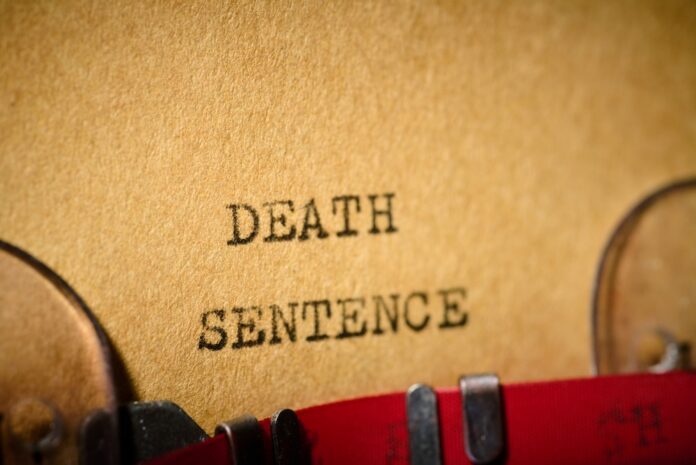Death,Sentence,Text,Written,With,A,Typewriter. Typewriter typing the words death sentence on paper