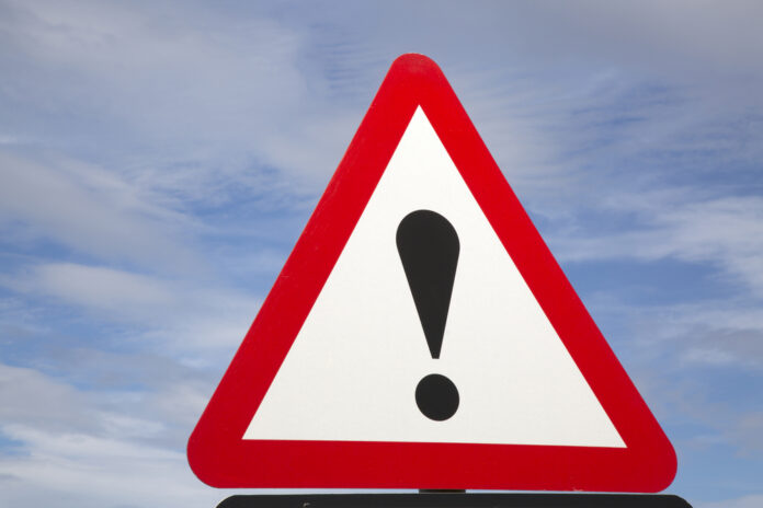 Exclamation,Mark,Traffic,Warning,Sign Warning road sign with exclamation mark against a cloudy sky