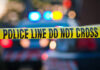 Cop Implicated in Killing Police tape and lights at crime scene.
